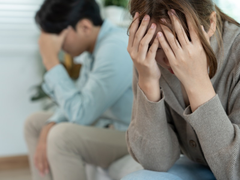 配偶者の不倫に頭を抱える女性・男性
